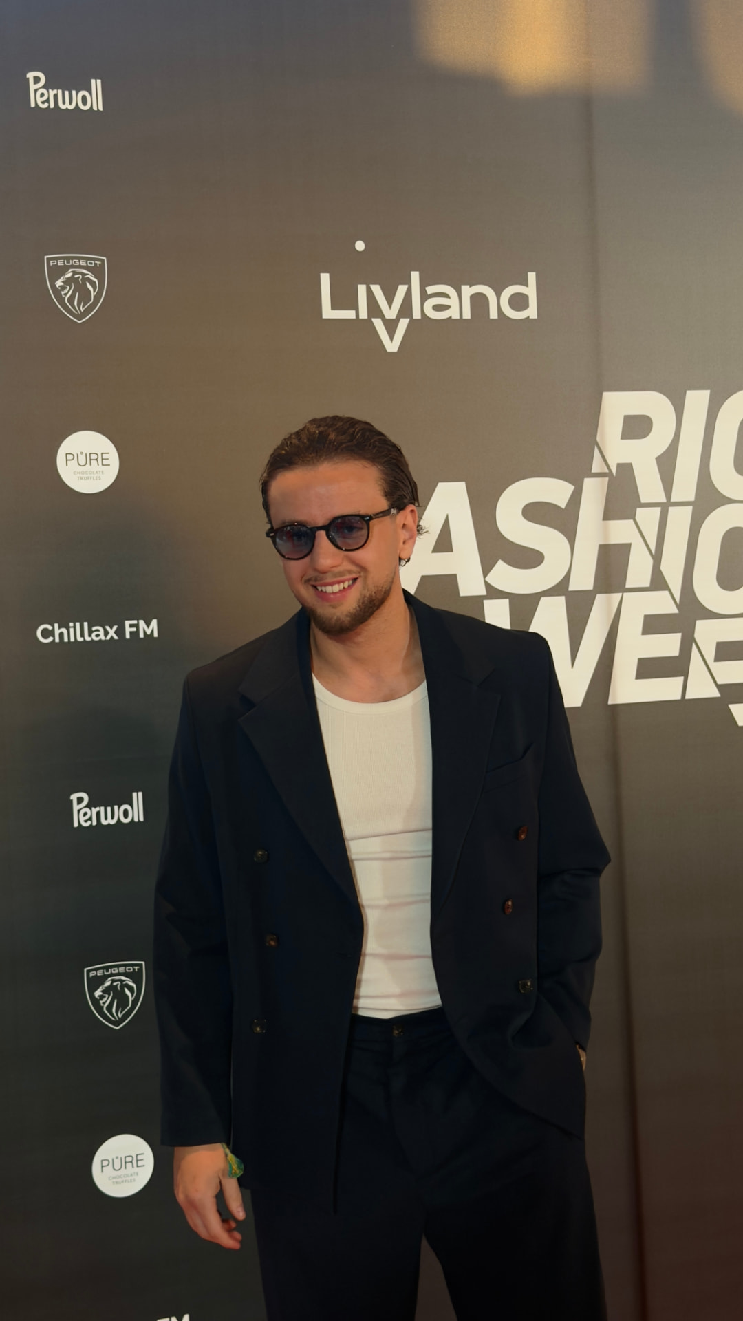 Rex in a tailored black suit at Riga Fashion Week