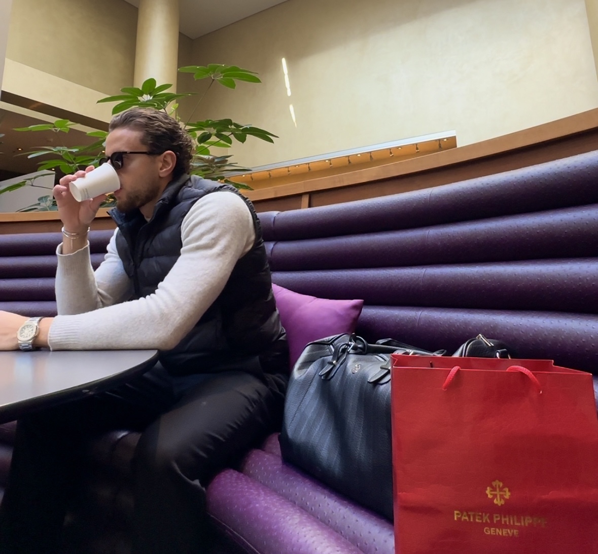 Rex seated in a quiet lounge, morning coffee